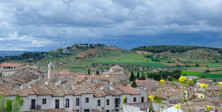 Panoramic view of Chinchon village, Community of Madrid, Castille-La Mancha, Spain. Dramatic stormy sky over suburban sceneryの写真素材