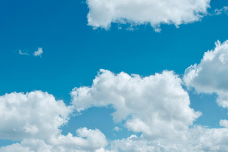 Cyan blue sky with clouds. Vivid springtime cloudscapeの写真素材
