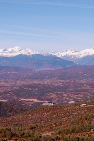 Vertical layered landscape from distant view point. Tranquil perspective and mountain with snowy picks on horizon. Serene skyline. Puerto de Monrepos, Aragon, norths of Spain.の写真素材