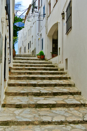 Stone staircase going up on the narrow street in beach town Calella de Palafrugel, Costa Brava, Catalonia, Spain. Concepts of relaxation, future, riseの写真素材