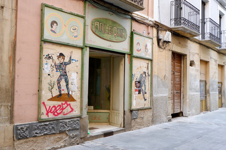 Closed abandoned entrance to service store downtown. Old concepts of small business facing recession, profit loss and bankruptcy. Jaca, Huesca / Spainのeditorial素材