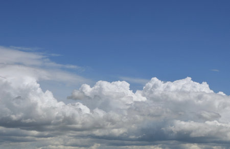 Aerial view on moody thunder clouds flying on horizon under blue sky. Gorgeous vibrant cloudscape...