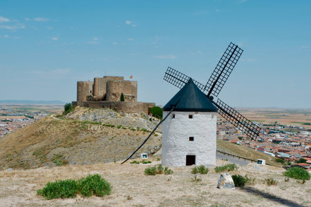 Whitewashed windmill near the castle in Consuegra town, Toledo province, Castilla-La Mancha, Spain. Popular weekend destination for people from Madrid. Also known as route of Cervantesのeditorial素材