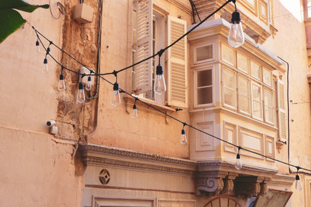 Aged stylish wooden balcony and window with shades on old residential building in downtown of Valletta, Maltaの写真素材