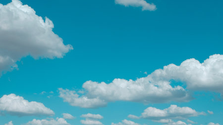 Dreamy cyan blue skies with cumulus clouds. Vivid open skyline. Concepts of heaven and peaceの写真素材