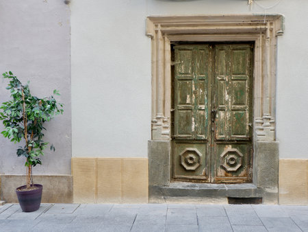 Closed old fashioned vintage door on the street of Jaca, Aragon, Spainの写真素材