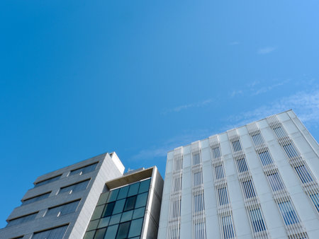 Office buildings top view against blue sky. Low angle. Background