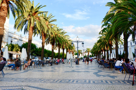 Olivenza town, Extremadura region, Spain - October 10, 2021: main promenade and people resting outside in open air cafesのeditorial素材