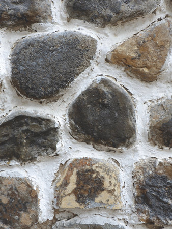 Round grey stones outside for backgrounds and backdrops. Textured rough ground. Vertical photoの写真素材
