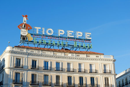 Madrid, Spain - November 13, 2021: classical building on Puerta del Sol with iconic Tio Pepe sign from 1935 of Gonzalez Byass Winery. Advertisement which became a history.のeditorial素材