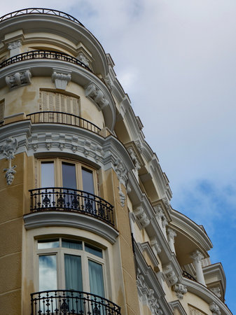 Rounded corner of classy baroque house downtown in Madrid, Spain. Elegant vintage Spanish classical architecture.の写真素材