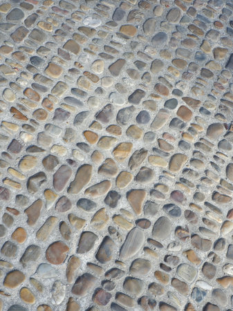 Pavement made of rounded sea stone. Sidewalk covered with natural materials.の写真素材
