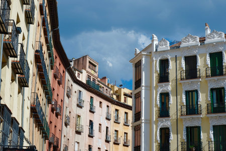 Classical buildings with balconies and windows with elegant ornate in downtown district of Madrid, Spain. Vivid colours, old-fashioned ornamental details.の写真素材