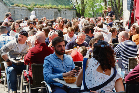 Bayonne, France - April 17, 2022: crowd of people having lunch on the outside terrace during the food festival.のeditorial素材