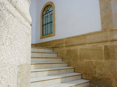 Minimal simple stairs of beige colour between buildings walls from outside in Avila, Castille Leon, Spain.の写真素材
