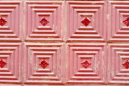 Red vintage tiles with geometric ornate on the outside wall in Porto, Portugal.の写真素材
