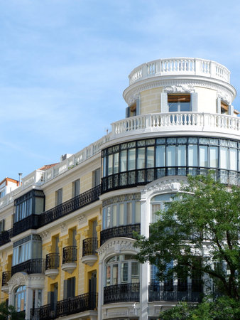 Rounded corner of elegant classical building in Fuencarral district downtown Madrid, Spain. Vertical photo.の写真素材