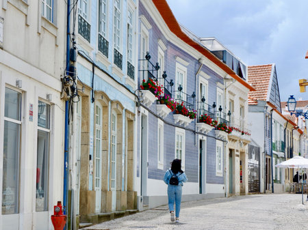 Aveiro, Portugal - May 16, 2022: daily life on the cozy colourful street downtown the city. Elegant portuguese architecture.のeditorial素材