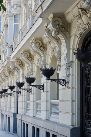 Elegant facade with classical details in baroque style in the central district of Madrid, Spain. Vertical photoの写真素材