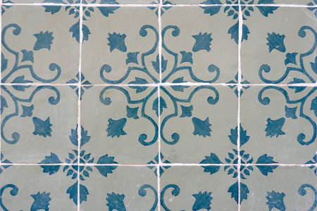 Vintage tiles of faded blue colours with floral ornate in Lisbon, Portugal.