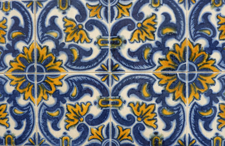 Colourful ceramic tiles with floral ornate in blue and yellow colours outside in Lisbon, Portugal.の写真素材