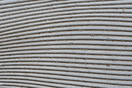 Uneven lines of street flooring of gray color on the pedestrian walk way the center of Madrid, Spain.の写真素材