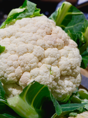 Fresh cauliflower head on the supermarket stand in Spain. Concepts of healthy eating. Vertical photos.の写真素材