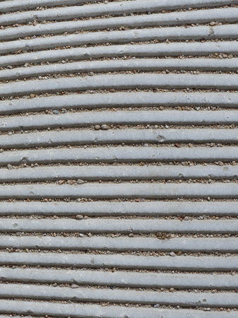 Uneven lines of street flooring of gray color on the pedestrian walk way the center of Madrid, Spain. Vertical photos.の写真素材