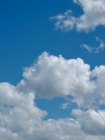 Fluffy white clouds on the cyan blue sky in Spain. Conceptual for dream and fantasy. Vertical photos.の写真素材