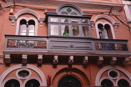 Long gray balcony with rounded decorative shapes on the authentic vintage building in Valletta, Malta.の写真素材