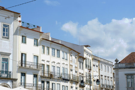 Whitewashed vintage classical buildings downtown Evora, Portugal.の写真素材