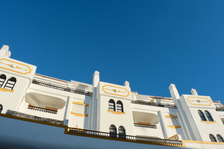Vintage whitewashed houses with arabic ornate of yellow color in âCarvoeiro, Algarve Coast, Portugal.の写真素材