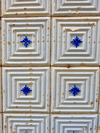 Vintage textured tiles in authentic Portuguese tradition on the street azulejos ceramic tile work. Porto, Portugal. Shabby worn surface of beige colour.の写真素材