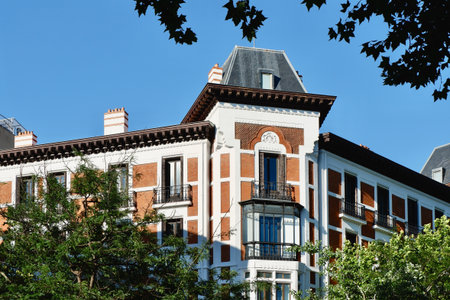 Corner of vintage old fashioned seen through vivid greenery in Chamartin district downtown Madrid, Spain. Spanish vintage architecture.の写真素材