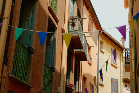 Cozy warm facades with festive decorations on the narrow French street in France.の写真素材