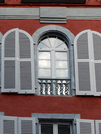 Vintage open window with shades in rural France seen from outside. French architecture.の写真素材
