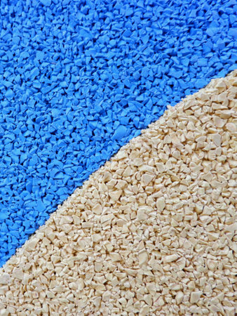 Vibrant blue and beige granules are arranged in a dynamic pattern, showcasing a mix of textures and colors suitable for various artistic endeavors and crafts.の写真素材