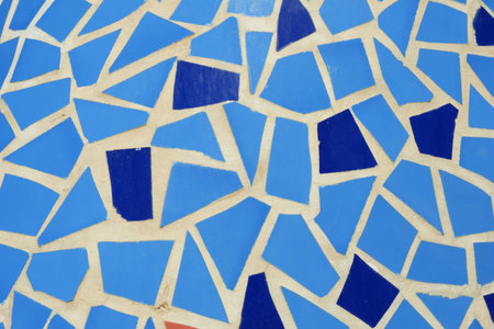 Intricate mosaic design composed of various shades of blue and lighter shades creating an...