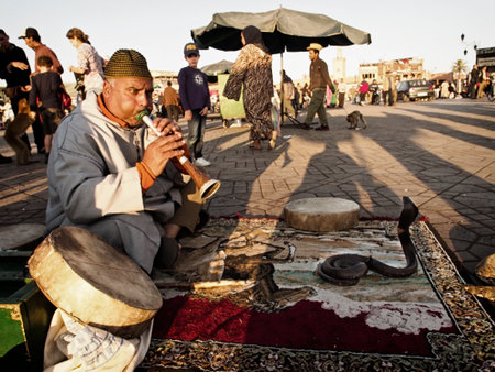 Marrakesh - MAR 28  Snake charmer at Djemaa el-Fna square, Morocco on Mar 28, 2013 のeditorial素材