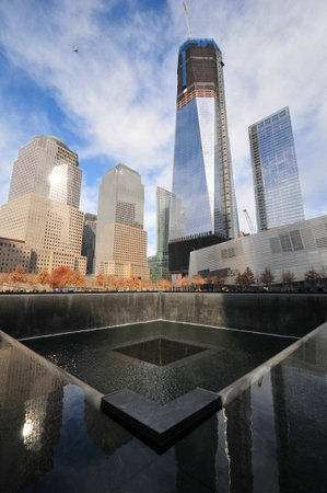 Daytime photo of the World Trade Center Memorial towards the new 1 World Trade Center under construction. のeditorial素材