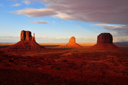 Sandstone formation in Monument Valley during sunset as storm clouds are rolling in.