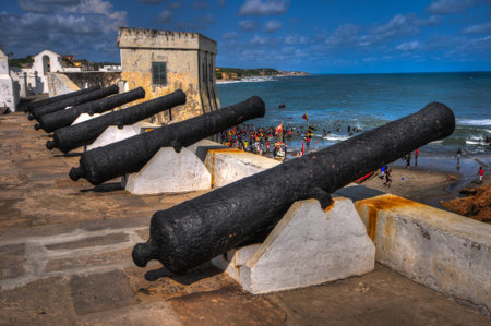 Cannons overlooking from Cape Coast Castle  Cape Coast Castle is a fortification in Ghana built by Swedish traders for trade in timber and gold  Later the structure was used in the trans-Atlantic slave trade のeditorial素材