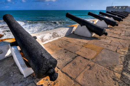 Cannons overlooking from Cape Coast Castle  Cape Coast Castle is a fortification in Ghana built by Swedish traders for trade in timber and gold  Later the structure was used in the trans-Atlantic slave trade のeditorial素材