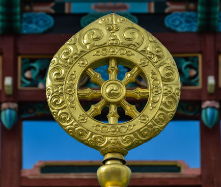 Dharmacakra or the Wheel of the Law  Golden symbol in the Ivolginsky Datsan in Ulan-Ude, Buryatia, Russia  The dharmacakra is one of the oldest known Buddhist symbols のeditorial素材
