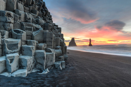Wide view of Reynisdrangar rock formations on Reynisfjara Beach at sunrise, Halsanefhellir, Iceland 