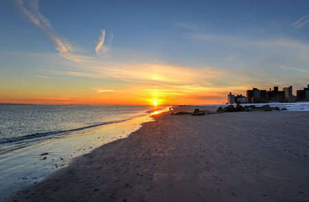 Sunset on Brighton Beach and Coney Island Beach, New York, also known as Little Odessa in the wintertime covered in snow.の写真素材
