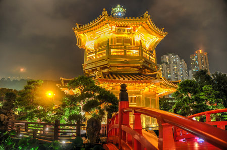 The Golden pavilion and red bridge in the Nan Lian Garden near the Chi Lin Nunnery, a famous landmark in Hong Kong.のeditorial素材