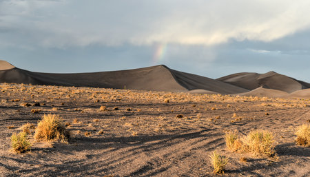 Sand Dunes and rainbows along the Amargosa Desert at sunset. Located in Nye County in western Nevada, United States, along the California-Nevada borderの写真素材