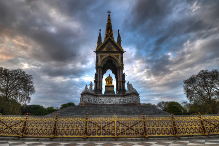 The London landmark in Hyde Park contrasting the neo-gothic monument against a threatening sky. 

The memorial was built by Queen Victoria in remembrance of her husband, Prince Albert.のeditorial素材