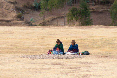 CHINCHERO, PERU - AUGUST 20, 2006: Female peasants collecting moraya potatoes.のeditorial素材
